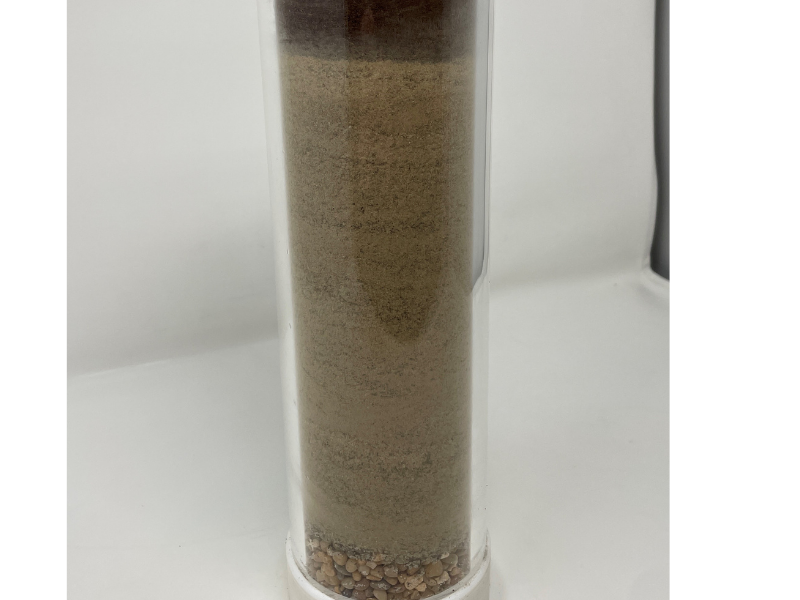 Long, cylinder of aquarium gravel, sand and soil mix and peat moss on top