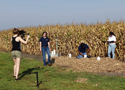 Researchers in field during video shooting