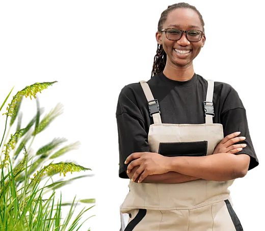 Woman in overalls standing near crops